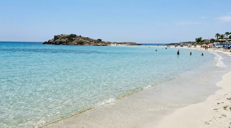 Beach in Cyprus showing white sand and clear water at Nissi Beach