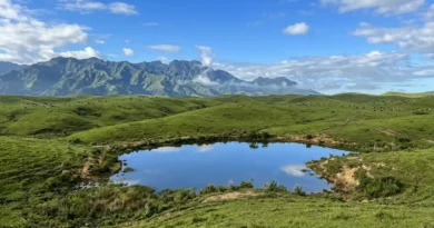 Communal Ranch grasslands and mountain views with pond in Impasug-ong Bukidnon