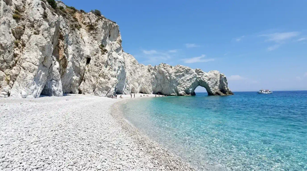Lalaria beach white pebbles and rock arch on Skiathos