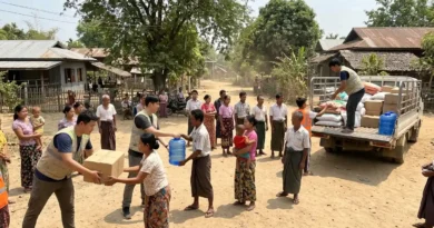 Volunteers from Food for the Hungry handing out supplies in a village