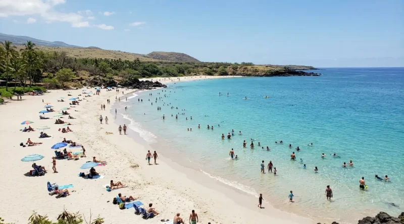 White sand Hapuna Beach with calm turquoise water and visitors swimming near Kona Hawaii